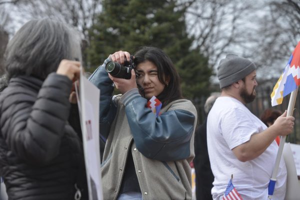 2024 Mass. High School Journalist of the Year Bella Ishanyan photographs a protest march. 
